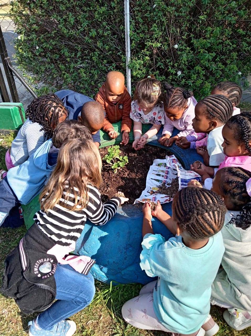 ECA pre-school learners enjoying a gardening activity